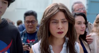 Movie still from “A Million Miles Away” (2023), directed by Alejandra Márquez Abella – A woman with long brown hair is looking at the camera; Close Up shot, Over the shoulder angle