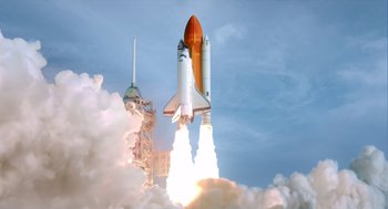 Movie still from “A Million Miles Away” (2023), directed by Alejandra Márquez Abella – A space ship is taking off from a launch pad; Extreme Wide shot, Low angle