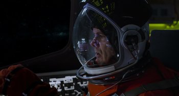 Movie still from “A Million Miles Away” (2023), directed by Alejandra Márquez Abella – A man in a space suit is looking into a window; Close Up shot, Low angle
