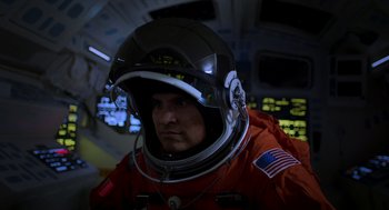 Movie still from “A Million Miles Away” (2023), directed by Alejandra Márquez Abella – A man in a space suit is wearing a helmet; Close Up shot, Low angle