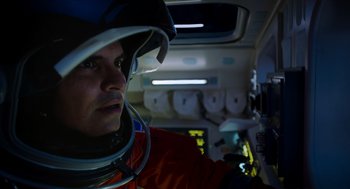 Movie still from “A Million Miles Away” (2023), directed by Alejandra Márquez Abella – A man wearing a helmet in an airplane; Close Up shot, Low angle