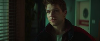 Movie still from “A Night at the Kindergarten” (2022), directed by Rafal Skalski – A person wearing a jacket; Close Up shot, Low angle