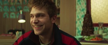 Movie still from “A Night at the Kindergarten” (2022), directed by Rafal Skalski – A person wearing a jacket; Close Up shot, Over the shoulder angle