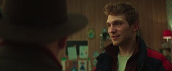 Movie still from “A Night at the Kindergarten” (2022), directed by Rafal Skalski – A man in a hat is talking to another man in a hat; Close Up shot, Over the shoulder angle