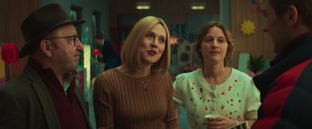 Movie still from “A Night at the Kindergarten” (2022), directed by Rafal Skalski – Two women standing next to each other in a room; Medium shot, Over the shoulder angle