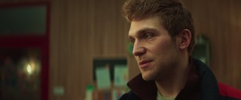 Movie still from “A Night at the Kindergarten” (2022), directed by Rafal Skalski – A person looking to his left; Close Up shot, Low angle