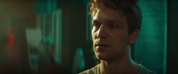 Movie still from “A Night at the Kindergarten” (2022), directed by Rafal Skalski – A person looking at the camera; Close Up shot, Over the shoulder angle