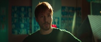 Movie still from “A Night at the Kindergarten” (2022), directed by Rafal Skalski – A person wearing a green shirt; Close Up shot, Over the shoulder angle