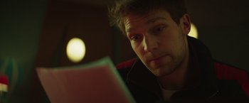 Movie still from “A Night at the Kindergarten” (2022), directed by Rafal Skalski – A person using a laptop computer; Close Up shot, Over the shoulder angle