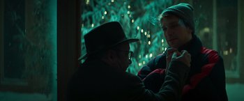 Movie still from “A Night at the Kindergarten” (2022), directed by Rafal Skalski – An older man sitting next to a young man; Close Up shot, Over the shoulder angle