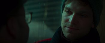 Movie still from “A Night at the Kindergarten” (2022), directed by Rafal Skalski – A person wearing a hat; Close Up shot, Over the shoulder angle