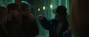 Movie still from “A Night at the Kindergarten” (2022), directed by Rafal Skalski – A man in a hat and glasses is talking to another man in a hat and glasses; Close Up shot, Over the shoulder angle