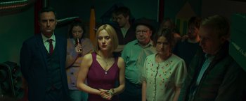 Movie still from “A Night at the Kindergarten” (2022), directed by Rafal Skalski – A group of people standing in a room; Medium shot, High angle
