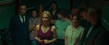 Movie still from “A Night at the Kindergarten” (2022), directed by Rafal Skalski – A group of people standing in a room; Medium shot, High angle