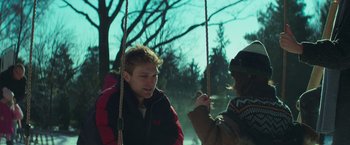 Movie still from “A Night at the Kindergarten” (2022), directed by Rafal Skalski – A man and a woman on a rope swing; Medium shot, Over the shoulder angle