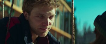 Movie still from “A Night at the Kindergarten” (2022), directed by Rafal Skalski – A person wearing a jacket; Close Up shot, Low angle