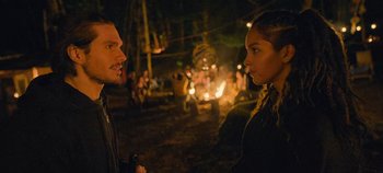 Movie still from “A Place to Fight For” (2023), directed by Romain Cogitore – A man and a woman talking in front of a bonfire; Close Up shot, Over the shoulder angle