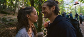 Movie still from “A Place to Fight For” (2023), directed by Romain Cogitore – A man and a woman standing next to each other in front of a tree; Close Up shot, Over the shoulder angle