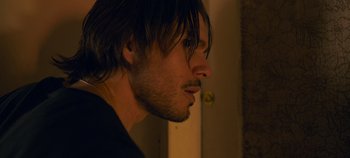 Movie still from “A Place to Fight For” (2023), directed by Romain Cogitore – A person with long hair; Close Up shot, Over the shoulder angle