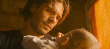 Movie still from “A Place to Fight For” (2023), directed by Romain Cogitore – A person holding a cell phone; Close Up shot, Over the shoulder angle