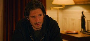 Movie still from “A Place to Fight For” (2023), directed by Romain Cogitore – A person with long black hair; Close Up shot, Over the shoulder angle