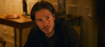 Movie still from “A Place to Fight For” (2023), directed by Romain Cogitore – A person with long hair; Close Up shot, Over the shoulder angle