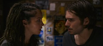 Movie still from “A Place to Fight For” (2023), directed by Romain Cogitore – A man and a woman face to face in a room; Close Up shot, Over the shoulder angle