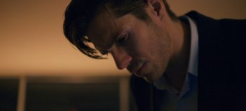 Movie still from “A Place to Fight For” (2023), directed by Romain Cogitore – A man's face as he looks down; Close Up shot, Over the shoulder angle