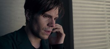 Movie still from “A Place to Fight For” (2023), directed by Romain Cogitore – A person talking on a cell phone; Close Up shot, Over the shoulder angle