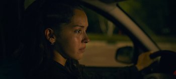 Movie still from “A Place to Fight For” (2023), directed by Romain Cogitore – A woman sitting in the driver's seat of a car at night; Close Up shot, Over the shoulder angle