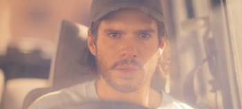Movie still from “A Place to Fight For” (2023), directed by Romain Cogitore – A person wearing a hat; Close Up shot, Low angle