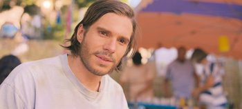 Movie still from “A Place to Fight For” (2023), directed by Romain Cogitore – A person with long brown hair; Close Up shot, Over the shoulder angle