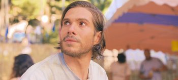 Movie still from “A Place to Fight For” (2023), directed by Romain Cogitore – A person with long hair; Close Up shot, Over the shoulder angle