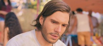 Movie still from “A Place to Fight For” (2023), directed by Romain Cogitore – A person with long hair; Close Up shot, Over the shoulder angle