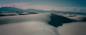Movie still from “A Quiet Place” (2018), directed by John Krasinski – A view of a desert landscape with mountains in the background; Extreme Wide shot, High angle