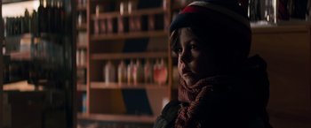 Movie still from “A Quiet Place” (2018), directed by John Krasinski – A young child wearing a hat and a scarf; Close Up shot, Over the shoulder angle