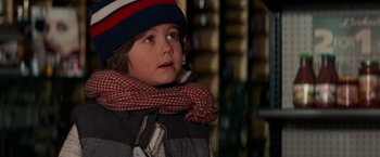 Movie still from “A Quiet Place” (2018), directed by John Krasinski – A little boy wearing a hat and a scarf; Close Up shot, Over the shoulder angle
