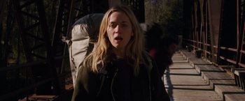 Movie still from “A Quiet Place” (2018), directed by John Krasinski – A woman with a backpack is standing in the street; Close Up shot, Low angle