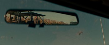Movie still from “A Quiet Place” (2018), directed by John Krasinski – A view of a man standing in the back of a car; Extreme Close Up shot, Over the shoulder angle