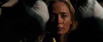 Movie still from “A Quiet Place” (2018), directed by John Krasinski – A person holding something in their hand; Close Up shot, Over the shoulder angle