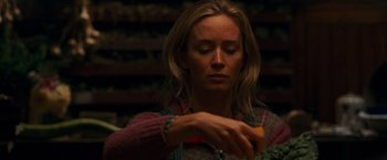 Movie still from “A Quiet Place” (2018), directed by John Krasinski – A woman holding an object in her hand; Close Up shot, Low angle