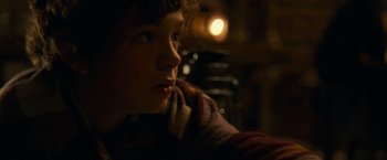 Movie still from “A Quiet Place” (2018), directed by John Krasinski – A young boy looking into the distance in the dark; Close Up shot, Over the shoulder angle