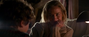 Movie still from “A Quiet Place” (2018), directed by John Krasinski – A woman with her hand to her face and a man with his hand to her mouth; Close Up shot, Over the shoulder angle