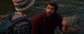 Movie still from “A Quiet Place” (2018), directed by John Krasinski – A man with a beard is talking to another man in the water; Close Up shot, Over the shoulder angle