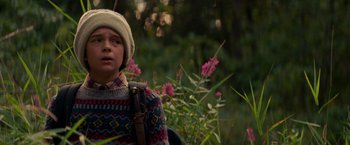 Movie still from “A Quiet Place” (2018), directed by John Krasinski – A young boy wearing a sweater and a white hat; Close Up shot, Low angle