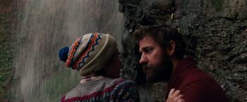 Movie still from “A Quiet Place” (2018), directed by John Krasinski – A man and a woman standing next to each other near a waterfall; Close Up shot, Low angle