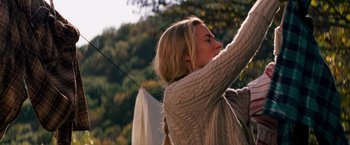 Movie still from “A Quiet Place” (2018), directed by John Krasinski – A woman hanging clothes on a clothes line outside; Medium shot, Low angle