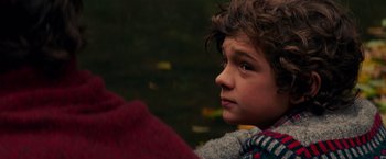 Movie still from “A Quiet Place” (2018), directed by John Krasinski – A young boy looking to his left while holding a blanket; Close Up shot, Over the shoulder angle