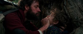 Movie still from “A Quiet Place” (2018), directed by John Krasinski – A man and a child are playing with a stick; Close Up shot, Low angle