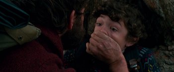 Movie still from “A Quiet Place” (2018), directed by John Krasinski – A man and a child with their hands over their mouths; Close Up shot, Over the shoulder angle